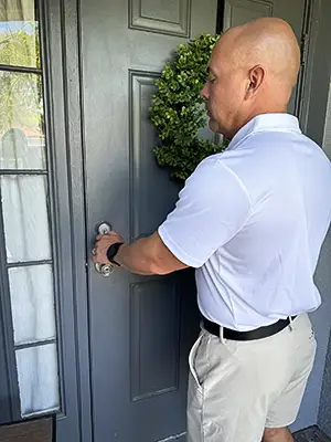 Checking door to ensure it is locked and safe.